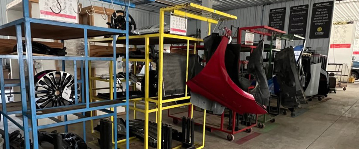 various vehicle parts sitting in racks in the warehouse at the Y Yard